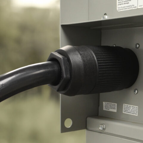 A NEMA 14-50P Assembly Plug Plugged into a RV Pedestal